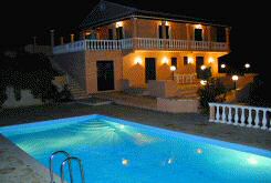 Lovely view of pool and villa by night.